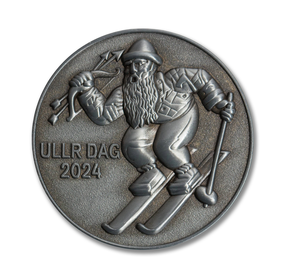 Medal with a depiction of a person on skis and archery, with 'ULLR DAG 2024' text.
